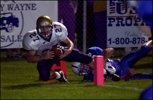 Maumee's Alex Junga is pushed out of bounds at the one-yard line by Anthony Wayne's Billy Benner.