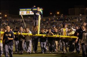 University of Toledo students carry off a goal post after the final gun made the Rocket upset over Pittsburgh official.