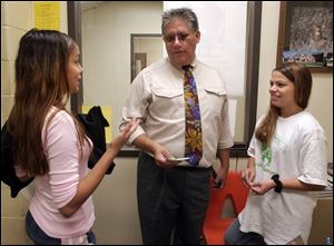 `You can go out and be a drug dealer, but that's not worth anything, and where does that get you in the end?' says Jose Luna, the Toledo Public Schools' coordinator of bilingual and related programs, talking with Sheila Lozano, left, and Syera Reyes at East To- ledo Junior High.