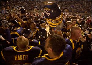 University of Toledo football players are surrounded by Rocket fans in a celebratory mood after UT defeated a top-10 ranked team for the first time.