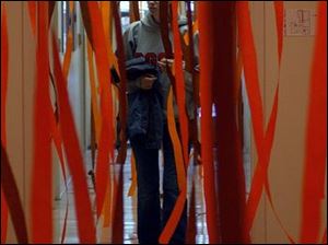 Bowling Green State University Student Bridget Tharp, junior in Journalism, makes her way  down a hallway of streamers decorated for the Homecoming Spirit Decorating Contest by the staff at Tucker Center for Telecommunications. Various contests are being held throughout the week to build spirit for the big football game on Saturday. Lisa dutton 09/30/2003 ROV  BGSU Streamers