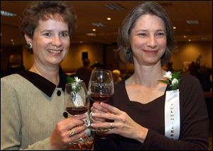 A TOAST: Judi Grodi, left, and Paulette Glauser raise their glasses to the di-vine success of the event.