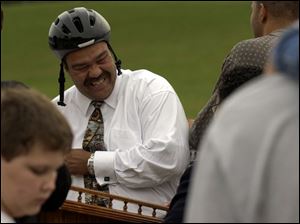 CTY skate10 A  Oct. 9, 2003-- Mayor Jack Ford has a laugh as she shows kids he's not afraid to wear his helmet during a press conference at the new Highland Park skate park. Ford did decline from trying his skills on a skateboard. Blade photo by Andy Morrison