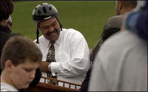 CTY skate10 A  Oct. 9, 2003-- Mayor Jack Ford has a laugh as she shows kids he's not afraid to wear his helmet during a press conference at the new Highland Park skate park. Ford did decline from trying his skills on a skateboard. Blade photo by Andy Morrison