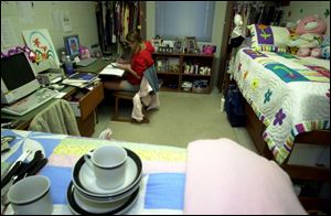 Marissa Jackson, 19, works on homework in her room in The Crossings. 