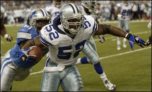 Dallas' Dexter Coakley (52) tries to shed Detroit's Ray Brown following an interception. 