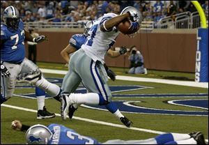 Dallas cornerback Mario Edwards leaps over the Lions' Joey Harrington en route to a TD after an interception. 