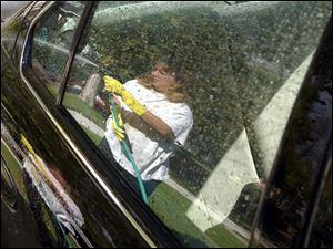 ROV CAR WASH 10/23/03 PHOTO BY LORI KING Toledoan Jennifer Johnson was going to wash her car at a car wash but decided the day wasn't as cold as she thought, as long was the sun was shining, so she washed it in her Ogden Ave. driveway.