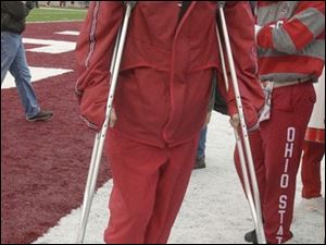 Ohio State's Drew Carter leaves the field at Indiana on crutches. He was injured in the game after making three catches for 75 yards.
