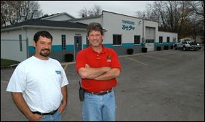 John Nagle, left, and Jay Cousino have made improvements to their body shop building. They want it to be attractive but put more emphasis on quality service and products.