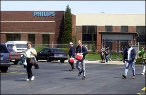 Employees leave the LG Philips Displays plant in Ottawa, Ohio, in April, 2000. Philips closed the factory in December, 2002, idling 1,100 workers. At one time, the firm employed 2,100 people there.