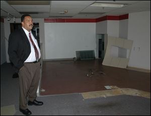 Mayor Jack Ford inspects space once occupied by a business in the Madison Building.