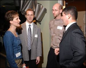 DOWN TO BUSINESS: From left, Jamie Dauel, left, John Hopkins Branam, Rob Dauel, and Brian Epstein hobnob.