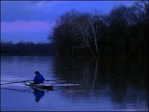 ROV RIVER 1. Neirel Bernblum (cq) rows up the Maumee River by Fransworth Metropark as cold settels in just after sunset on Friday evening.  Bernblum has been rowing on the river for over 20 years.  Lucas Mobley / The Blade