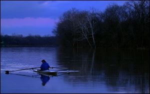 ROV RIVER 1. Neirel Bernblum (cq) rows up the Maumee River by Fransworth Metropark as cold settels in just after sunset on Friday evening.  Bernblum has been rowing on the river for over 20 years.  Lucas Mobley / The Blade