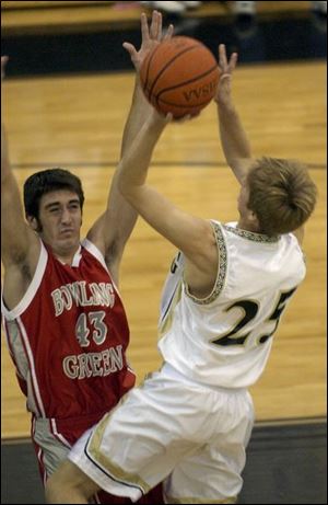 Bowling Green's Jimmy Green draws a charge from Perrysburg's Nick Andrews. Green scored eight points.