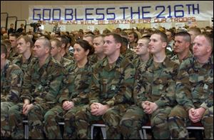 Members of the 216th Engineer Battalion, Company C, listen to speakers at a send-off ceremony held yesterday.