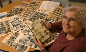 'This is history,' says Violet Gaige, with her new book and yellowed copies of the newsletter.