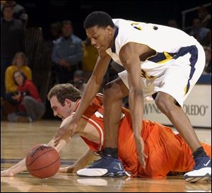 Bowling Green's John Reimold hits the floor to battle Toledo's Anton Currie for the ball. Reimold had 10 points and six assists but missed a final 3-pointer for the Falcons, who fall to 8-9, 4-3 in the MAC.