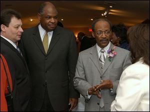 rel L to R Bernie Quilter lucas county clerk of courts, Eugene Sanders supt of TPS, Rev Otis Gordon, and Betty Schultz.  photo taken at a reception for rev Otis at warren ame church.  photo by lori king  Jan 17, 2004