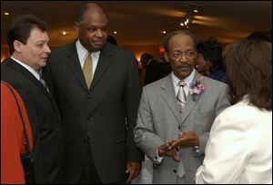 rel L to R Bernie Quilter lucas county clerk of courts, Eugene Sanders supt of TPS, Rev Otis Gordon, and Betty Schultz.  photo taken at a reception for rev Otis at warren ame church.  photo by lori king  Jan 17, 2004