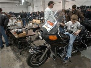 cty swap25p 3 January 25, 2004. Ryan Fereza, 10, of Toledo sits on his dad's 1982 Honda Gold Wing during the motorcycle swap meet at the Lucas County Recreation Center Sunday. Blade photo by Jeremy Wadsworth
