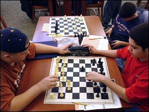 l to r-Waite High School Chess Club students Ralph Shively,15, Nick Hyslop,16, and Daniel Alvarez,14 practice their skills at the main library in downtown  Toledo,OH. Lisa Dutton 1/04 2004 NBR lib04p  2