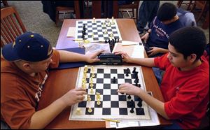 l to r-Waite High School Chess Club students Ralph Shively,15, Nick Hyslop,16, and Daniel Alvarez,14 practice their skills at the main library in downtown  Toledo,OH. Lisa Dutton 1/04 2004 NBR lib04p  2