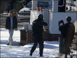 CTY STANDOFF31P 1 31/04 PHOTO BY LORI KING A woman is released from the a home on Oak Grove while the man who supposedly held her hostage stands on the porch prior to being taken peacefully into custody by law enforcement officials.