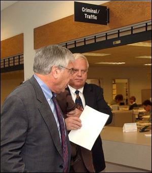 Ray Kest, right, with his attorney, Sheldon Wittenberg, leaves Sylvania Municipal Court after having paid his fine.