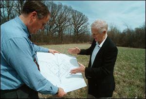 Engineer David Shoop, right, explains to Milton F. Knight how the new nature center will fit into the area where they are standing. The Wood County Park District first put the project on its drawing board in 1999.