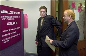 John, left, and Tom Meinecke walk into the Lucas County Courthouse to apply for a marriage license.