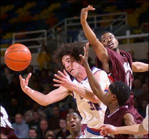 Kevin Bingle of St. Francis de Sales, center, goes for the ball while being defended by Scott s Antwan Loving, front, and Frederick Allen, who was called for a foul on the play.