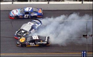 Michael Waltrip, center, loses control of his Busch Series car during practice yesterday. Waltrip was not injured.