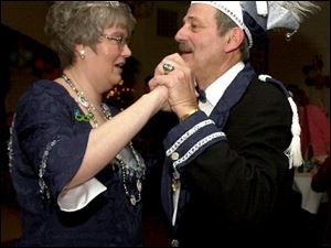 NBR mardi21p -  Kris Abel and Bob Richards share a dance with one another on Saturday, Feb. 21, 2004 at the Mardi Gras party held at Oak Shade Grove in Oregon. The two were named the Mardi Gras Prince and Princess for 2004 at the event put on by the American Turners.(The Blade/Jason Braverman)