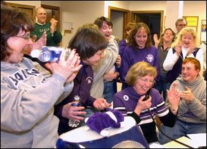 Supporters cheer the narrow passage of a 1.25 percent income tax to support the Swanton Local School District.