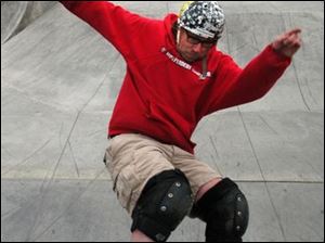 Rov Photo by Don Simmons Mar 3, 2004  Toddo Swalla  enjoys the new skatebroad park at Highland Park.  In the background is friend Rob LeBarr who also was testing his skills on a skatebroad