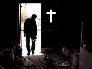 ROV Church Work  March 2, 2004-- A construction worker heads out of St. Joseph's Catholic church after finishing up some work Tuesday. The church at Erie and Locust streets is undergoing renovations. Blade photo by Andy Morrison