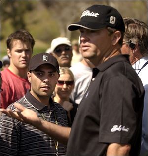 Davis Love looks for the heckler, and eventually the heckler was identified as the man in the Tiger Woods cap. Love refused to continue until the man was removed.
