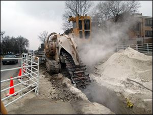 Rov Photo by Don Simmons Mar 18, 2004   Machine used to make trench and chew through stone for sewer work along Wooster St in Bowling Green for thewiding project