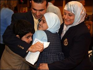 cty match18p 1 March 18, 2004. MCO student Adel Itawi celebrates being matched to the Michigan State residency program with his brother Jad,  sister Sally, and his mother Fayze Thursday at the Great Hall of the Stranahan Theater. Blade photo by Jeremy Wadsworth