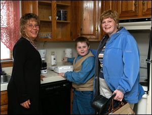 Respite care coordinator Helen Riley, left, joins Jacob Hanline and his mom, Bonnie Hanline, in the home opened recently by the Wood County Board of Mental Retardation and Developmental Disabilities.