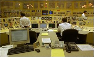 Reactor operators monitor and adjust operations in the Davis-Besse plant control room.