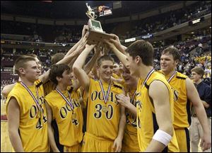 Ottawa-Glandorf hoists the trophy for the Division II state basketball championship. The Titans had been elminated the past two years in the regional by Akron St. Vincent-St. Mary and LeBron James.