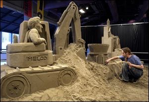 SPT March 28, 2004 - Sand artist Carl Jara of Cleveland creates a one of a kind sand sculpture featuring local construction suppliers and businesses for the Sandsational Science spring break event to be held at COSI April 3-18.  The featured sponsoring businesses are Kuhlman Corp., Melco Inc., and Miller Brothers Construction.  Blade photo by Dave Zapotosky