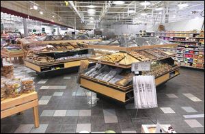 Shiny tile flooring and modernized display stations are part of the renovated bakery area in a Grand Rapids store.