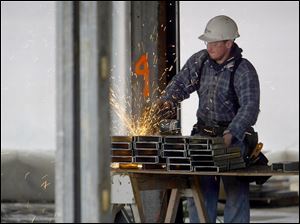 ROV hospconst 01 - A worker cut metal studs to form walls for the new Bellevue Hospital which is being built on the West side of Bellevue, this will replace the old one when construction is completed. Allan Detrich/The Blade
