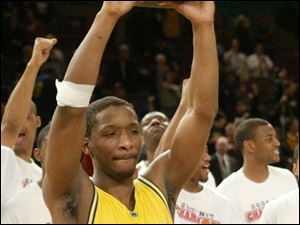 Michigan guard Daniel Horton holds the MVP trophy after leading the Wolverines (23-11) to an NIT championship. He scored 14 points in the title game after getting 15 in the semifinal - both team highs.