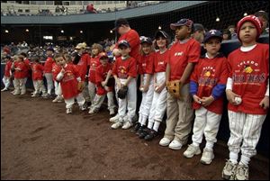 A long line of mini-Mud Hens patiently wait to be introduced along with the players as part of the Opening Day ceremonies at Fifth Third Field. The game drew a record 12,250 fans.