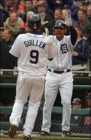 Carlos Guillen is greeted at the plate by Carlos Pena after scoring a run. The 4-0 Tigers battled back from a 3-0 deficit for an easy victory.